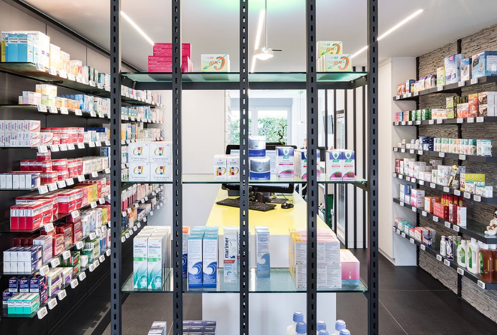 Vue intérieure d'une pharmacie rénovée dans le style moderne par ArchiPharma vue rangement